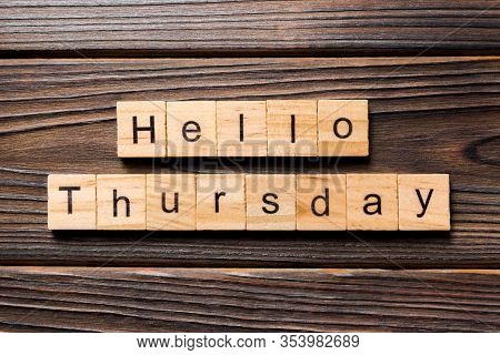 Hello Thursday Word Written On Wood Block. Hello Thursday Text On Wooden Table For Your Desing, Conc