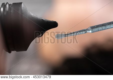 Glue For Eyelashes Squeezed Out Of A Tube With A Soft Brush, A Drop Of Glue Close-up, Macro Shooting