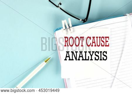 Root Cause Analysis Text On Sticky On Notebook With Pen And Glasses , Blue Background