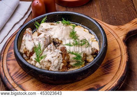 Chicken Chkmeruli In Georgian Brown Bowl Side View