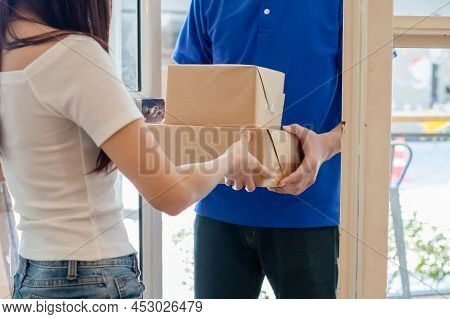 Asian Young Woman, Customer Received Cardboard Box From Delivery Man, Postman Or Messenger While Loc