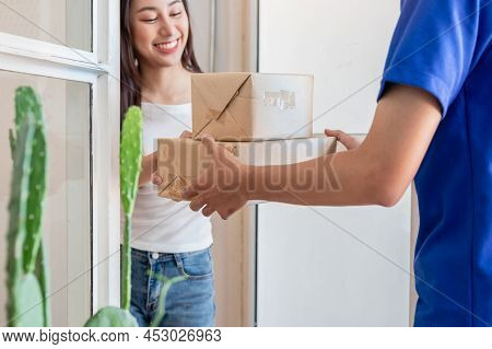 Asian Young Woman, Customer Received Cardboard Box From Delivery Man, Postman Or Messenger While Loc