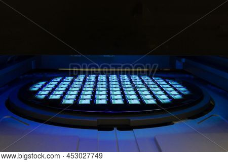 Silicon Wafer With Chips In Uv Lighting. Neon. Ultraviolet Lithography.