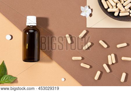 Flat Lay Composition Of Various Dietary Supplements On Brown Background. Vitamin Complexes Concept.
