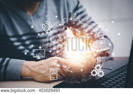 Smart Phone With Icon Business Concept,business Hand Holding A Virtual Globe With Financial Icons Fu