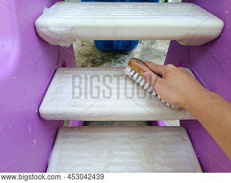 Scrubbing Brush Cleaning On The Stairs Of Children's Toys.
