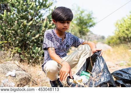 Serius Young Kid Collecting Trash On Hill Top During Summer Vocation - Concept Of Environmental, Vol