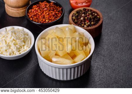Canned Pineapple Chunks In A White Bowl On A Dark Concrete Background