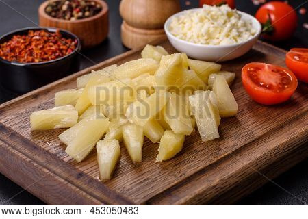Canned Pineapple Chunks In A White Bowl On A Dark Concrete Background