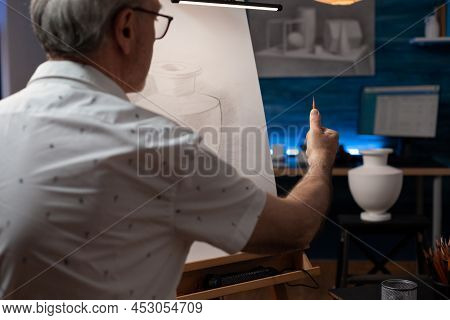 Focus On Hand Of Creative Senior Artist Looking At Plaster Vase Measuring Proportions Using Pencil D
