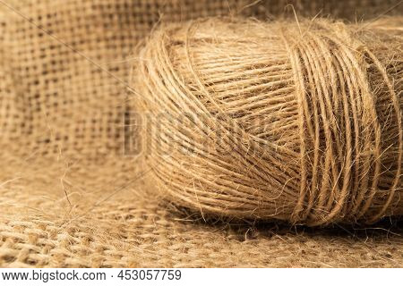 Linen Rope Roll And Natural Linen Fabric Texture.  Soft Light And Isolated View.