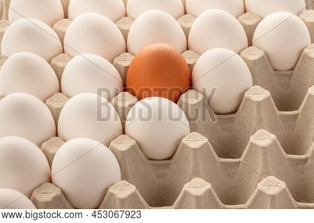 Chicken Eggs Brown And White In A Tray. Some Slots In The Tray Are Empty. Top View At An Angle.