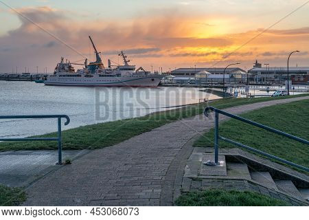 Cuxhaven, Germany - 02.25.2022: Sunrise By The Sea With Helgoland Ferry Docked In The Port Of Cuxhav