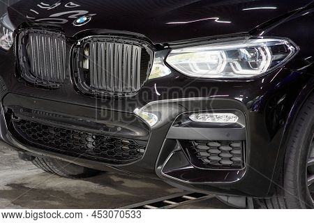 The Bmw Car, Covered With A Protective Shiny Black Paint Film, Is In A Repair Shop. Ppf Polyurethane