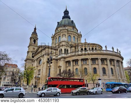 Budapest, Hungary - April 9, 2022: St. Stephen's Basilica Seen From The Busy Road Full Of Cars.