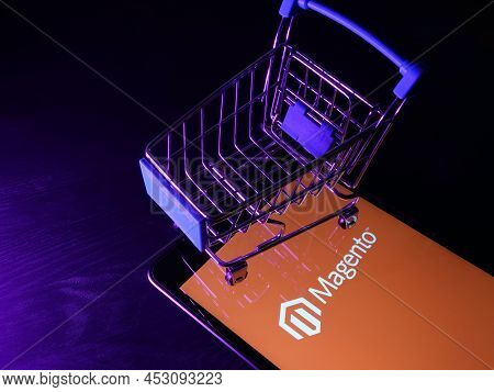 Kyiv, Ukraine - March 30, 2022. Magento Ecommerce Platform Logo And Shopping Cart.