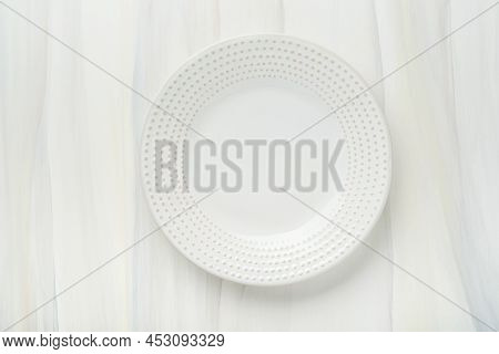 Ceramic Empty White Plate. Rustic Vintage Set Of White Plate, Wooden Spoon On Light White Wooden Bac
