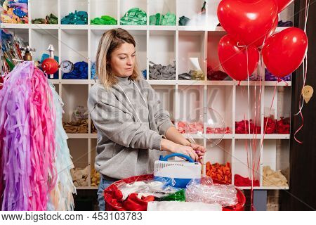 Woman Aerodesigner Stretches Air Clear Balloon Before Inflating It Helium.