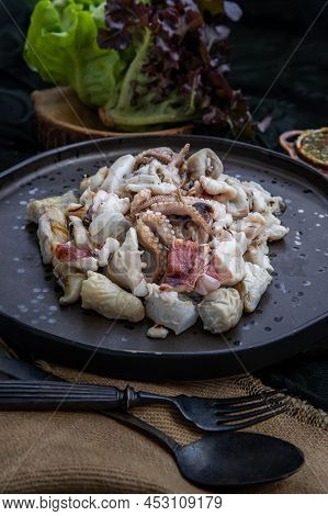 Close-up Of Fresh Grilled Squid, Octopus Tentacles And Squids Eggs On Ceramic Plate Served With Fres