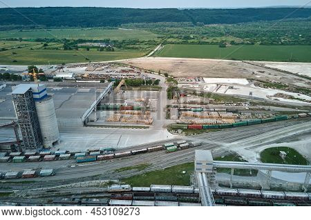Aerial View Of Cargo Train Cars Loaded With Construction Goods At Mining Factory. Railway Transporta