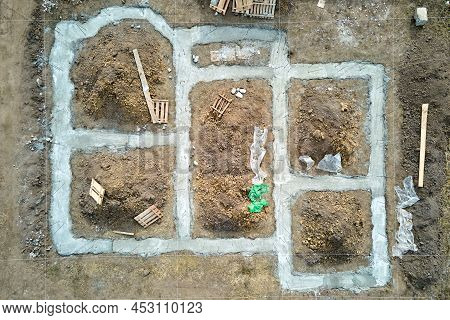 Top Down Aerial View Of Building Works Of New House Concrete Foundation On Construction Site