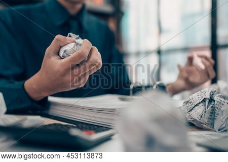Serious Investors Have A Mad Crump Paper And Angry While Working  On The Desk.  Accounting And  Fina