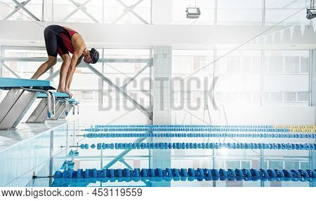 Professional Woman Swimmer In A Starting Position In The Pool