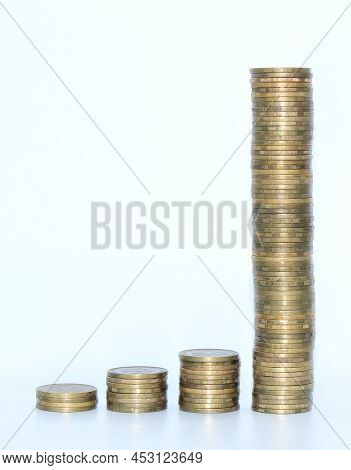 Get Rich Quick Concept. Accumulation Of Money. Investments. Coins On White Background.