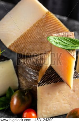 Cheese Board Of Various Types Of Soft And Hard Cheese. Spanish Manchego Cheese, International Dairy 