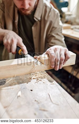 High Angle Medium Close-up Of Man Working In Carpentry Workshop Cutting Mortise In Wood Plank Using 