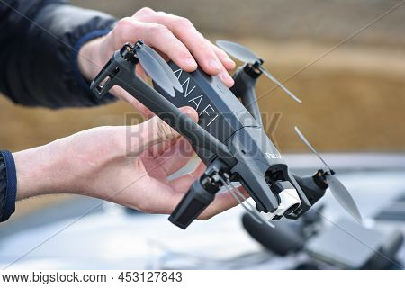 10 April 2022 - Krakow, Poland: Man Performing Battery Replacement Drone Parrot Anafi Thermal Before