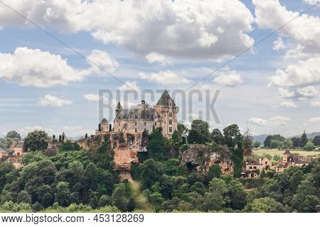 Panoramic View Of Chateau De Montfort Which Stands On Large Outcrop Of Rock Above Village And River 