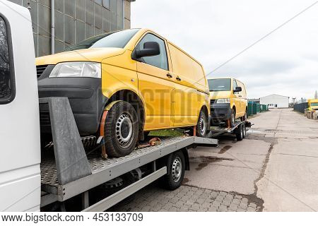 White Small Cargo Truck Car Carrier Loaded With Two Yellow Van Minibus On Flatbed Platform And Semi 
