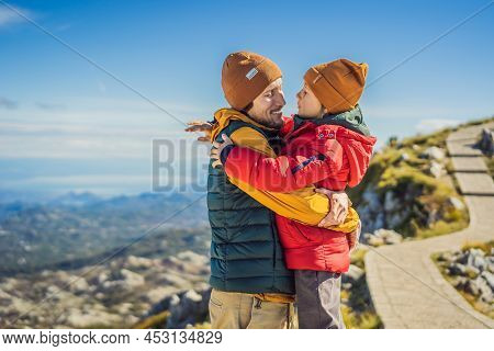 Dad And Son Travellers In Mountain Landscape At National Park Lovcen, Montenegro. Travel To Monteneg