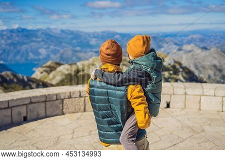 Dad And Son Travellers In Mountain Landscape At National Park Lovcen, Montenegro. Travel To Monteneg