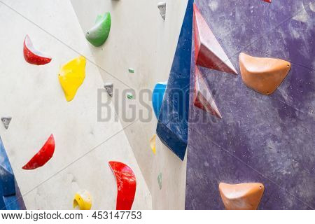 Stone Hooks Or Grips On The Artificial Climbing Wall In Bouldering Gym.