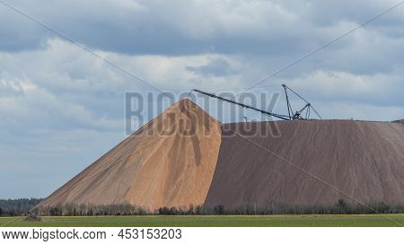Giant Spreader Or Absetzer Machinery. A Large Dumper On A Landfill With Potash Ore. Extracting And M