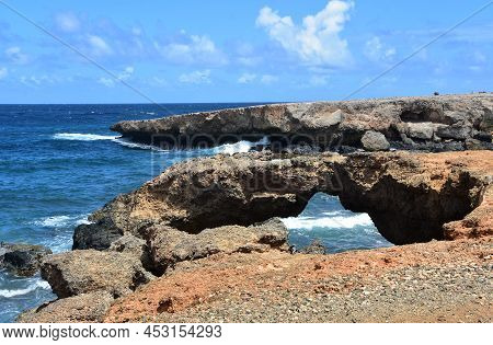 Gorgeous Views Of Natural Bridge At Black Sand Beach In Aruba.