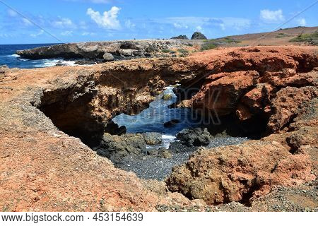 Stunning Scenic View Of A Natural Bridge On The Coast Of Aruba.