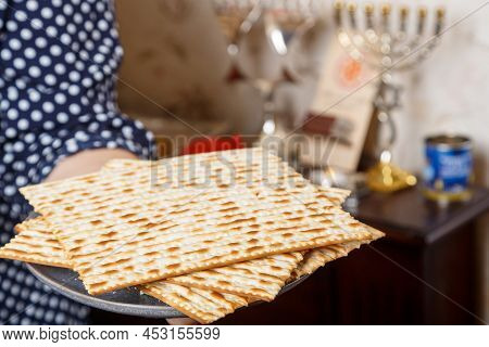 Matzah In The Hands Of A Jewish Woman For Sedar On Pesach. Horizontal Photo