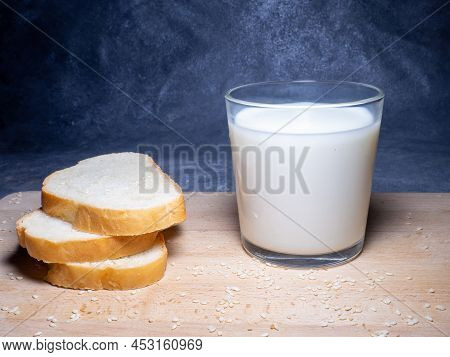 Sliced ​​loaf Bread For Breakfast With Butter. Food On The Table. Flour Products. Pieces Of Bun . Co