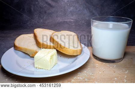 Pieces Of Rye And White Bread With A Glass Of Milk On A Plate. Healthy Breakfast. Bakery Products Wi