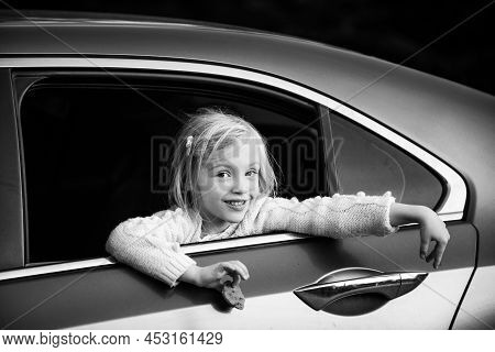 Sweet Female Child Looking Trough Car Window. Cute Pensive Girl Looking Through Window Of Car.