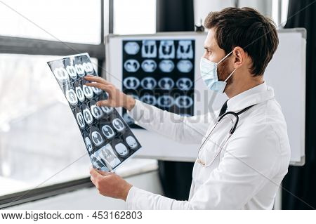 Smart Professional Caucasian Doctor In A Medical Uniform, Protective Mask, A Pulmonologist, A Therap