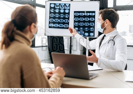 Caucasian Smart Doctor, Therapist, Pulmonologist, In Medical Uniform And Protective Mask, Shows The 