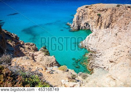 Idyllic Fyriplaka beach surrounded by beautiful cliffs on Greek island of Milos