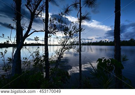 Beautiful Late Afternoon Cloudscape Over Pine Glades Lake In Everglades National Park, Florida Refle