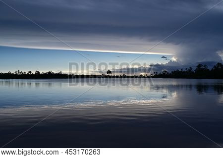 Beautiful Late Afternoon Cloudscape Over Pine Glades Lake In Everglades National Park, Florida Refle