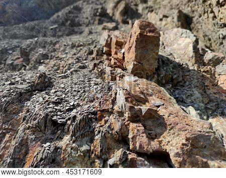 Geodesy. Stone Texture. The Rock Is Brown And Red. Mineral Background. Design From Natural Materials