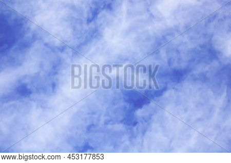 Fluffy White Skies On A Blue Background, Clouds Texture. Soft Focus